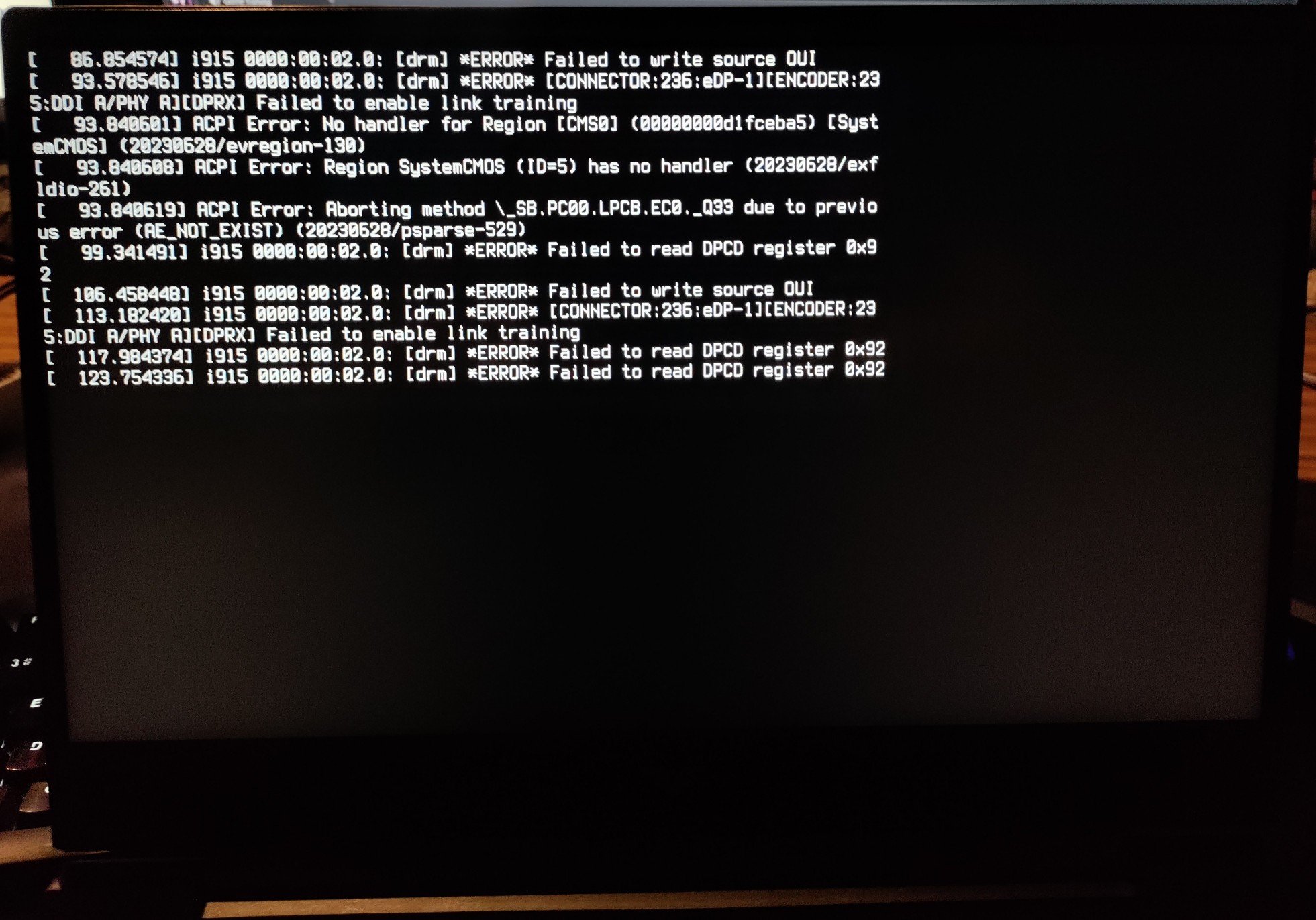 a picture of a laptop black screen, with error messages after it tried to suspend itself.
