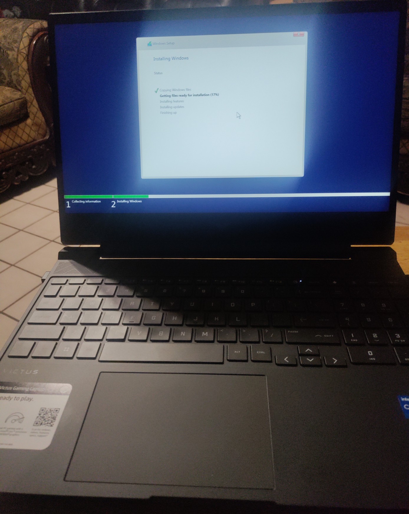 a picture of a laptop, having windows being reinstalled on it.